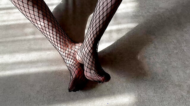 Girl in black fishnet pantyhose caresses her legs