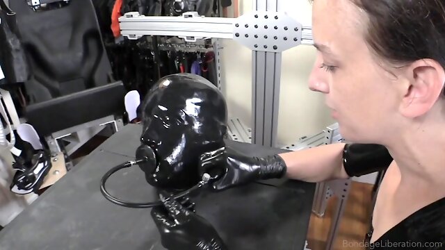 Gimp in latex is dominated and punished by a cruel lady