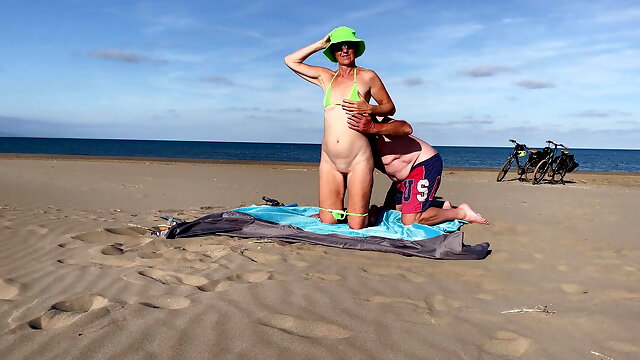 Unfaithful wife humiliates her husband on the beach
