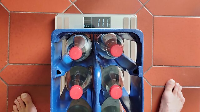 I lift a box of water bottles with my balls. It weights about 11kg.