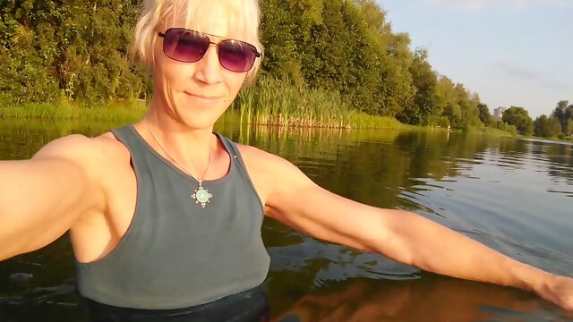 Swimming in the lake in sportswear at sunset...Moist stretch pants and a T-tee-shirt...