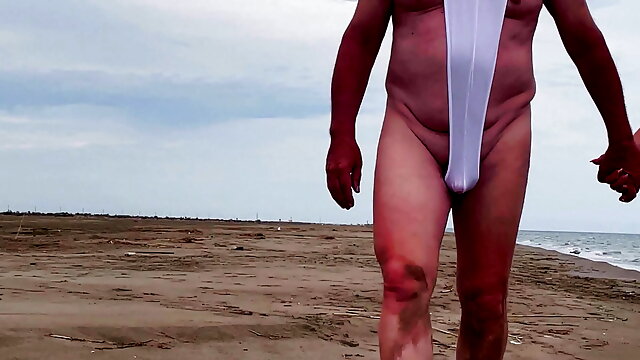 My husband in a chastity cage is exposed on a beach