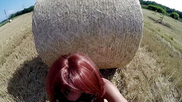 Slutty Redhead MILF sucks in a field with a Buttplug. Huge Facial Cumshot