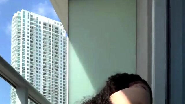 Ebony teen with sensational ass fucks a dildo on a balcony