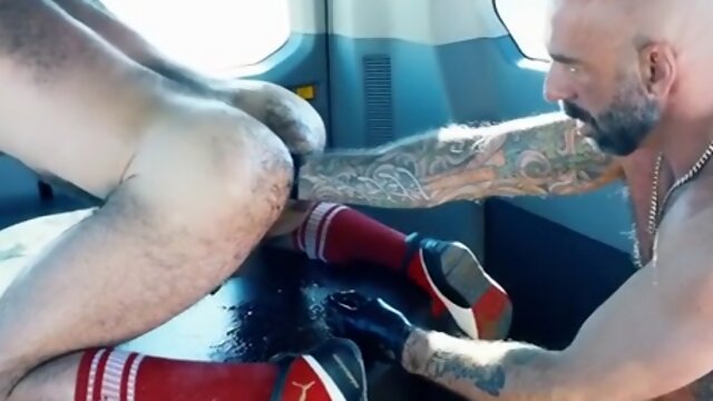 Fisting DILF fucks her boyfriends ass in a van with a gloved fist