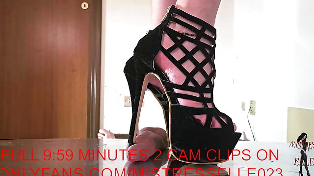 Mistress Elle grinds her slave's cock in her platform high heel sandals