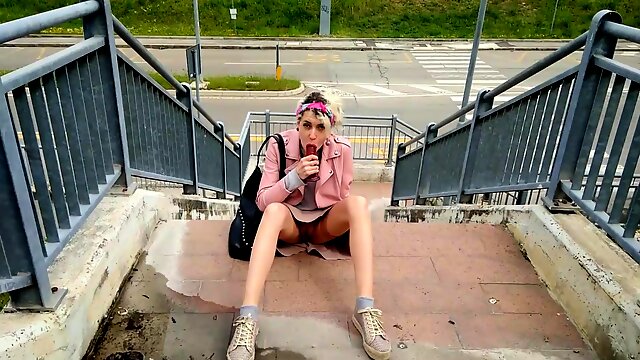 Wild European girl driving herself to climax in public