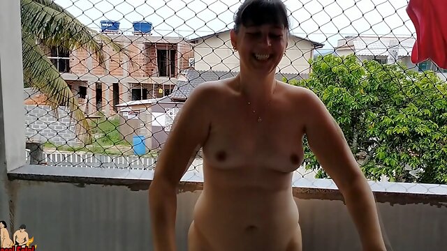Wife works nude on balcony teasing her cuckold husband