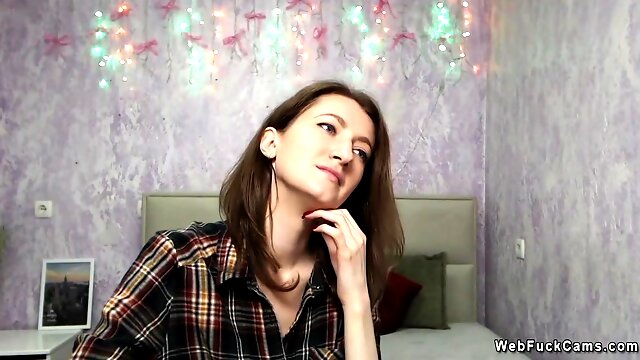 Brunette amateur babe posing clothed on solo webcam