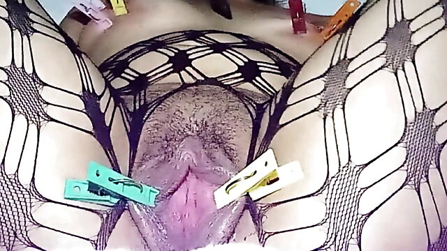 Stretched vaginal lips inserting a big cucumber and squirting