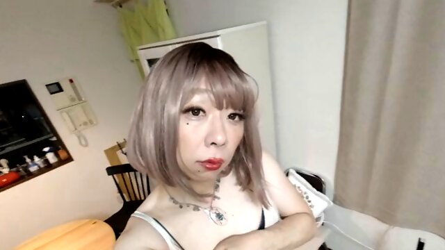 Japanese crossdresser cums while working with his hands in a summer dress