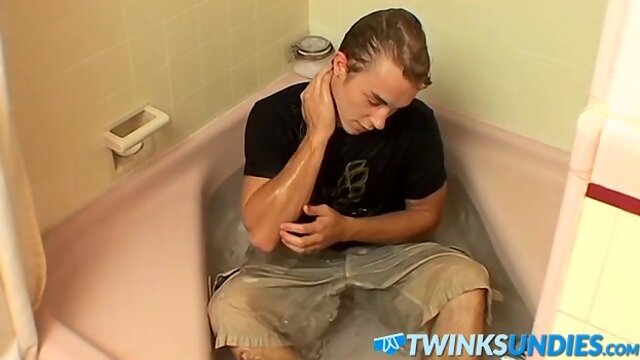 Muscular jock plays with his cock while taking nice bath
