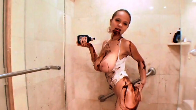 Watch Paris Milan spread chocolate all over her body while showering solo