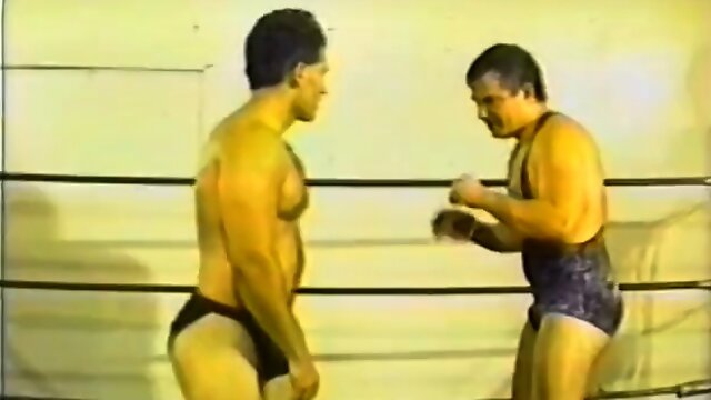 Two professional wrestlers fight naked in a boxing rink