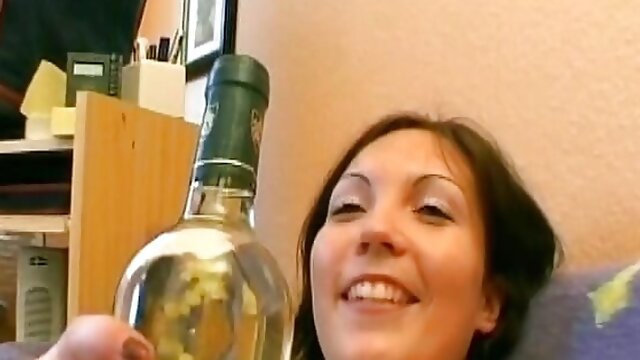 Hot German girl with big tits stuffing a bottle in her shaved pussy