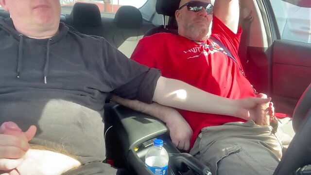 Stroking our dicks in the car in the parking lot