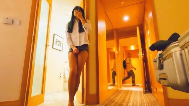Chinese ladyboy wearing black stockings and hip skirt opens the hotel room door and ejaculates