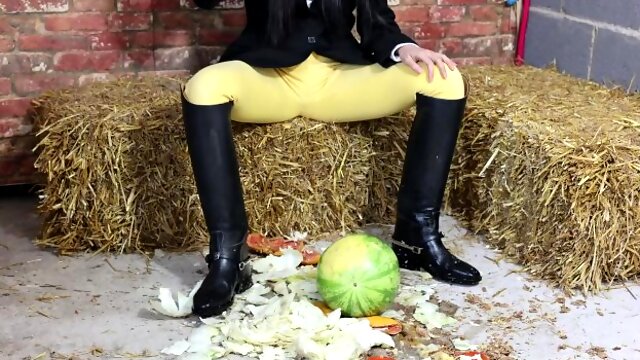 Equestrian Louisa crushing fruit wearing boots