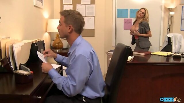 By showing off her big milf tits the blonde boss seduces her office employee