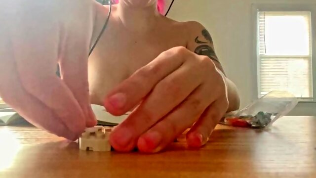 Topless lego building with natural saggy tits