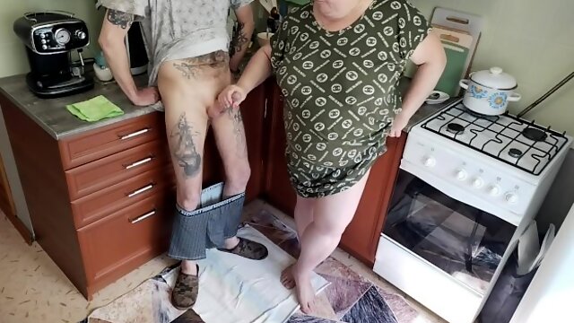 A fat woman jerks off my dick in the kitchen and I cum powerfully
