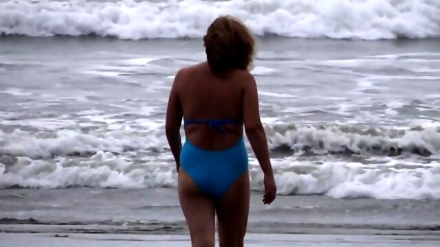Beautiful stepmom showing off on the beach and making cocks hard