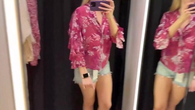 An adult film actress changes clothes in a fitting room